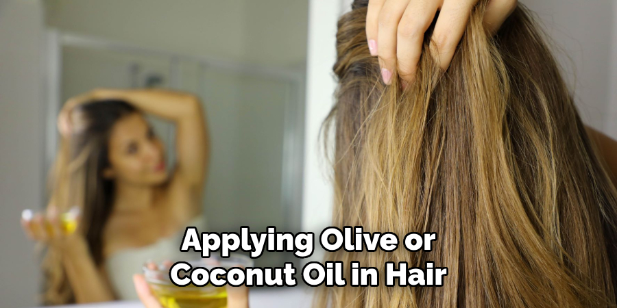 applying olive or coconut oil in hair