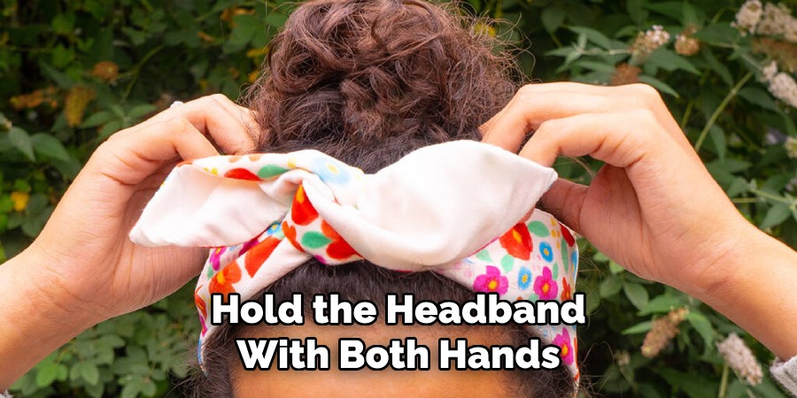 Hold the Headband
With Both Hands