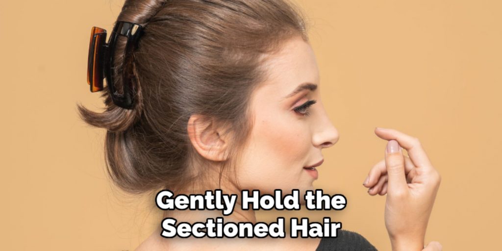Gently Hold the
Sectioned Hair