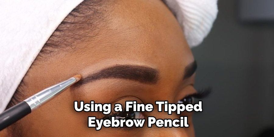 Using a fine-tipped eyebrow pencil