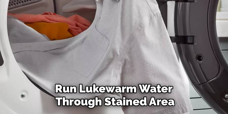 Run Lukewarm Water 
Through Stained Area